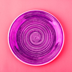 Saturated pink plate on the light red background