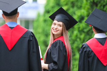 Young students in bachelor robes outdoors