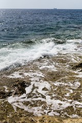 Sea surf on the rocky coast of Malta.