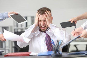 Overworked businessman having panic attack in office