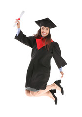 Jumping female graduate with diploma on white background