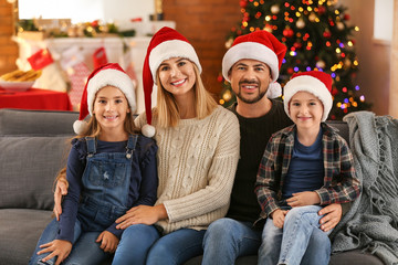 Happy family in room decorated for Christmas