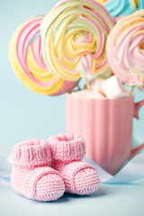 pair of small baby socks on blue background with copy space for your warm message, baby shower, first newborn party background, copy space, cute minimal postcard