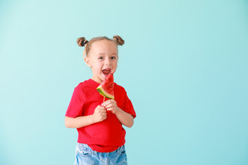 Cute little girl with slice of fresh watermelon on color background