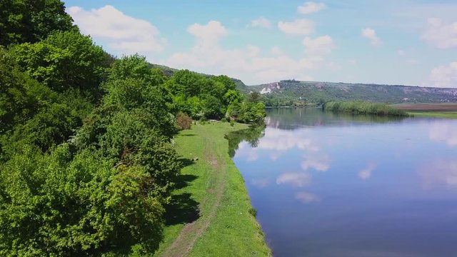 Flight over the river and forest at spring time. Dniester river of Moldova republic.