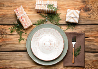 Beautiful table setting for Christmas dinner on wooden background