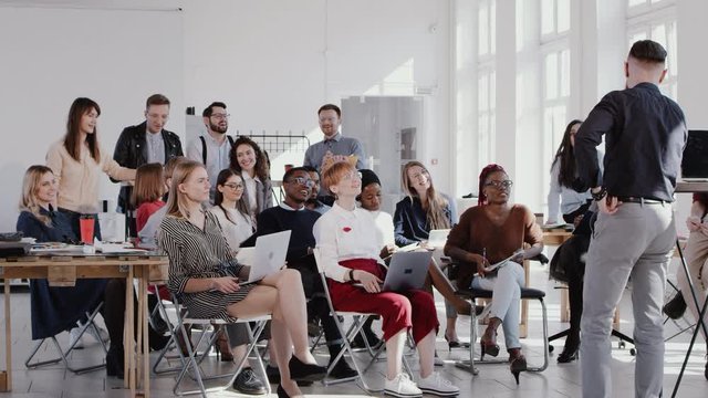 RED EPIC Happy middle aged male finance expert motivating workers at modern healthy workplace office seminar slow motion