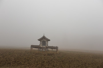 The old chapel in a fog  Alps, Austria