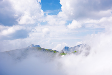 stunning scenery of cloud formations in high mountains of romania. fagaras ridge in dynamic weather condition. beautiful nature background. dreams in the air concept