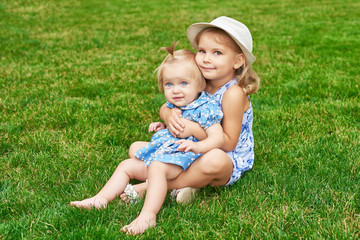 sisters in the park, two girls on a summer picnic