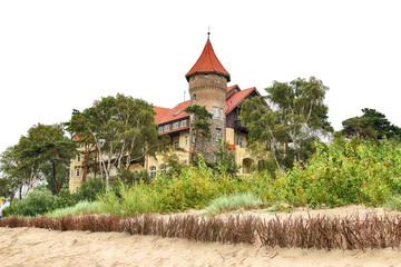 LEBA, POLAND - JULY 23, 2019: Neptun Castle on the Baltic Sea in Leba, Poland. In 1903 almost on the beach , the build of this interesting architectonically building was begun (completed in 1907). © promesaartstudio