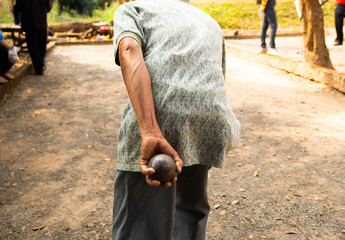 Hand of holding petanque ball. people at sport playing game petanque.