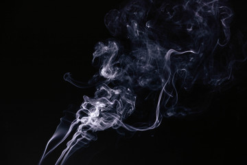 White wavy smoke on black background