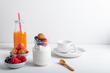 yogurt with fruit on a breakfast table on a white background