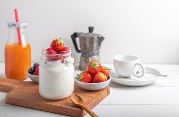yogurt with fruit on a breakfast table on a white background