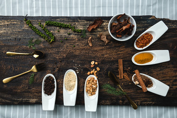 Fototapeta na wymiar Various colorful herbs and spices on wooden table. Top view of spices and herbs. Spices and herbs over on wooden table background.