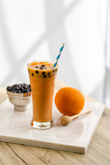 Bubble milk tea with bubble topping for tea or other beverage on the wood table with copy-space for textures and wall Natural light background