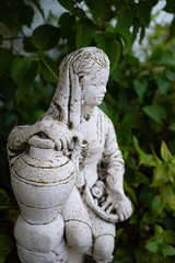 Fototapeta na wymiar Portrait of a cement statue in the garden