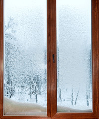 wooden window in the snow, view of snowy trees