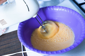 mixer whip eggs to a froth with sugar