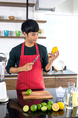 Men are looking at Lemmon fruits in the kitchen.