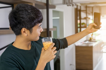 Handsome young man selfie happily in the kitchen