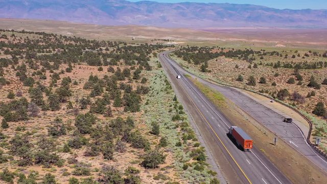 Aerial over a truck traveling on highway 395 to reveal the Owens Valley and the Eastern Sierra Nevada mountains of California.
