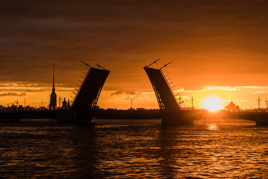 Saint Petersburg, Russia. View of the drawbridge and sunrise on the Neva river. Palace bridge. 