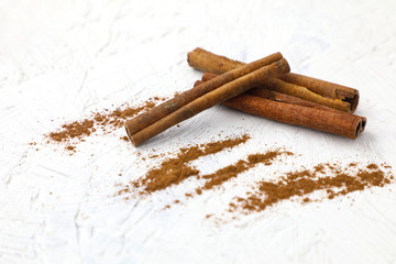 Cinnamon is a fragrant spice . Popular spices , cinnamon sticks and powder on white background.