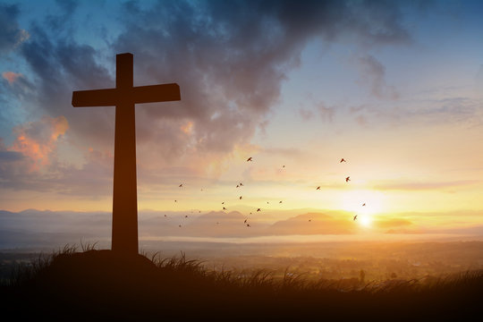 The cross with sunset in the sky background