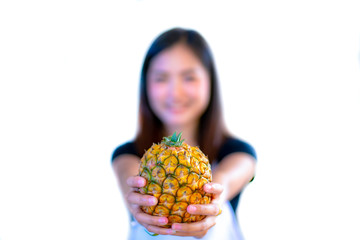 Portrait of Asia girl giving pineapple