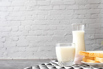 breakfast table with glass of milk, jug of milk.