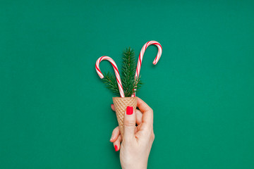 Christmas card with candy canes in waffle cone