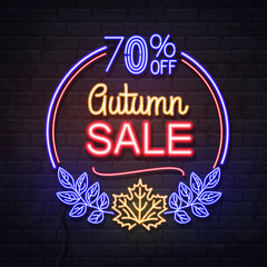 Neon sign autumn big sale with maple leaves on brick background. Vintage electric signboard.