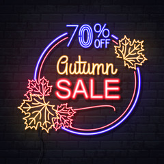 Fototapeta na wymiar Neon sign autumn big sale with maple leaves on brick background. Vintage electric signboard.