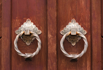 Wooden doors with antique ring handles