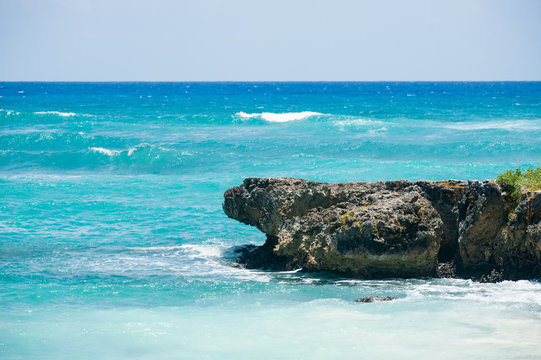 Rock formation in Caribbean sea with azure water color