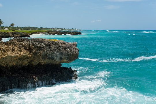 Beautiful rocky coast of Dominican Republic in sunny day. Turquoise water color of Caribbean sea