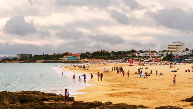 Carcavelos, Portugal. Aerial view of the famous Carcavelos beach near the Lisbon, Portugal during a cloudy day. Time-lapse of people at the beach, panning video