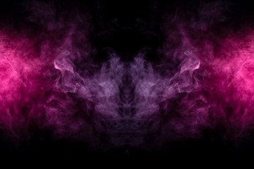 Smoke of different blue, red and pink colors in form of horror in the shape of the head, face and eye with wings on a black isolated background. Soul and ghost in mystical symbol. Print for clothes.