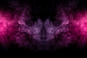 Smoke of different blue, red and pink colors in form of horror in the shape of the head, face and eye with wings on a black isolated background. Soul and ghost in mystical symbol. Print for clothes.