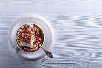 Hot chocolate and marshmallow sprinkled with chocolate chips.