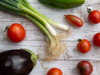 Variety of fresh vegetables on wooden surface