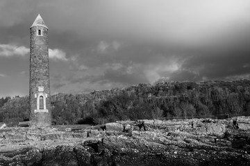 Black & White Image of Largs Lichen Covered Rocky Foreshore and the Pencil Monument Commemorating...