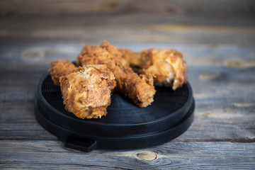 fried, chicken legs in a grill batter on an old wooden background