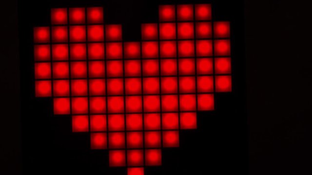 Romantic red heart in the form of pixels. Valentine's Day. Close-up. Stop motion.