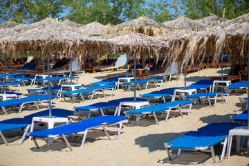 Fototapeta na wymiar chairs and umbrellas on the beach