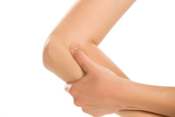 Woman pressing a reflex point with her thumb on her arm.