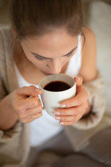 Women hands holding cup with hot coffee
