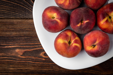 Peach on dark wooden background.